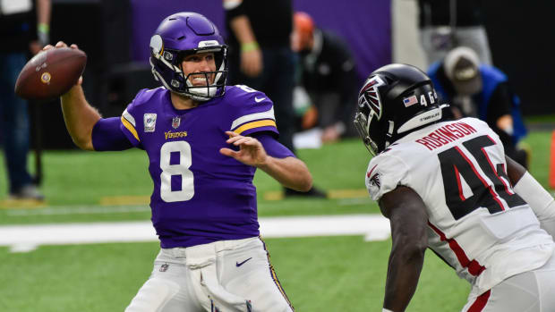 Oct 18, 2020; Minneapolis, Minnesota, USA; Minnesota Vikings quarterback Kirk Cousins (8) prepares to throw a pass as Atlanta Falcons linebacker Edmond Robinson (46) rushes during the first quarter at U.S. Bank Stadium.